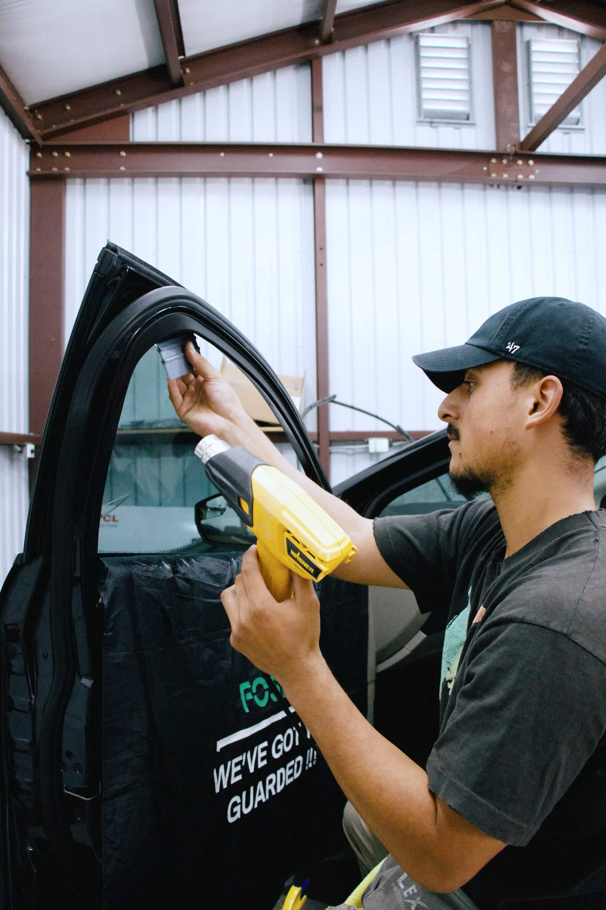 Installer applying premium tint film with precision